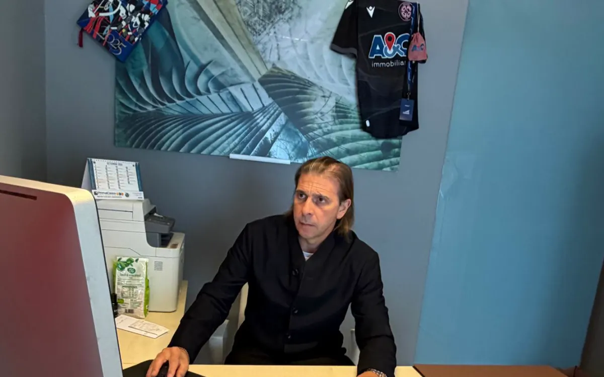 Alessandro Cavassi al lavoro nel suo ufficio, con la maglia A&C appesa alla parete